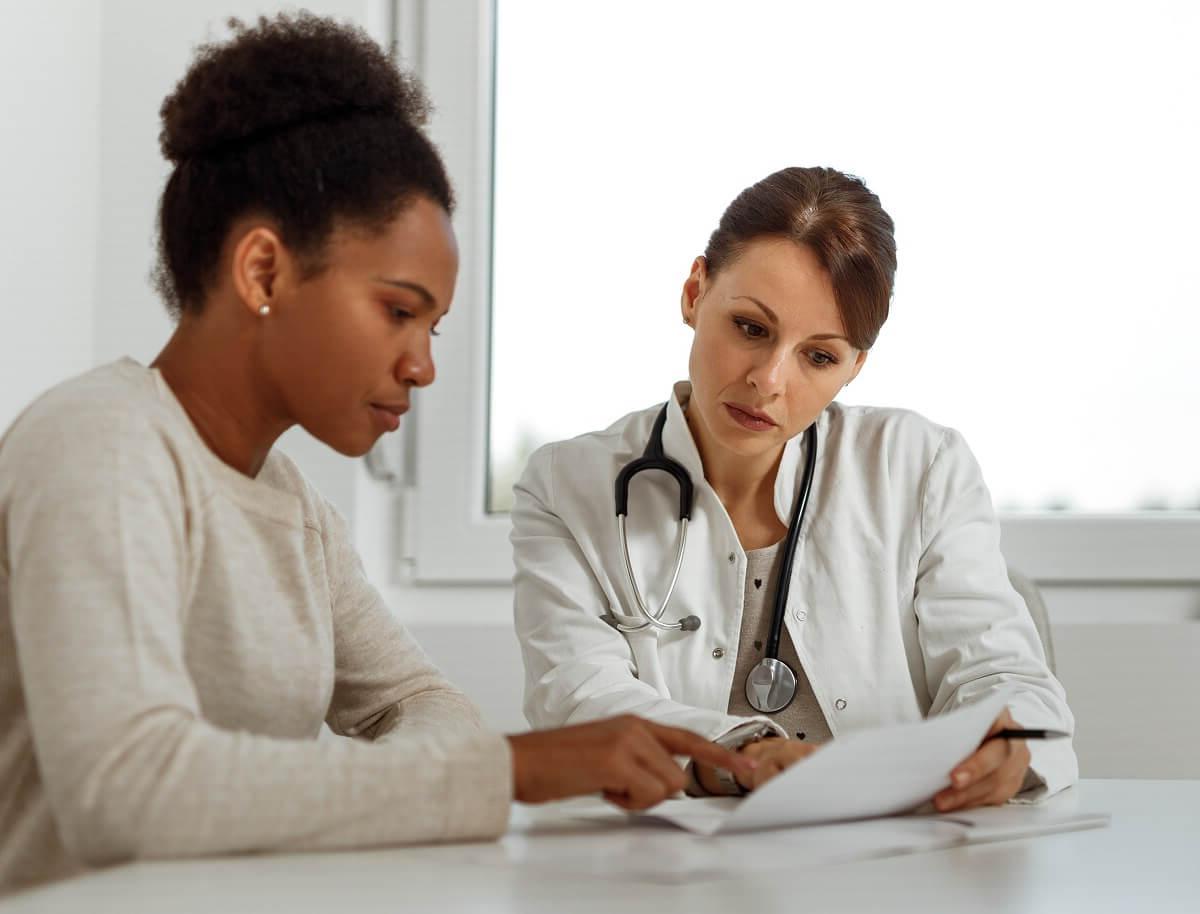 DNP Nurse Practitioner Consulting Diagnosis with Adult Patient